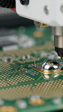 Macro probe view of robotic laser micro soldering tiny contact pin on printed circuit board in high tech electronics factory