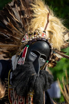 A dancer wears a Dan tribe wooden mask with an elongated nose and blond fur mane during a sacred ceremony dance, Bafing, Gboni, Ivory Coast