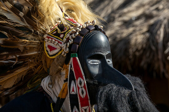 A beaded headband and cowrie shells frame a Dan tribe sacred mask during a ceremonial dance, Bafing, Gboni, Ivory Coast
