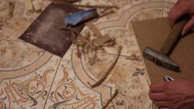 Craftsman sanding a wooden frame with sandpaper for smooth surface finishing during carpentry work