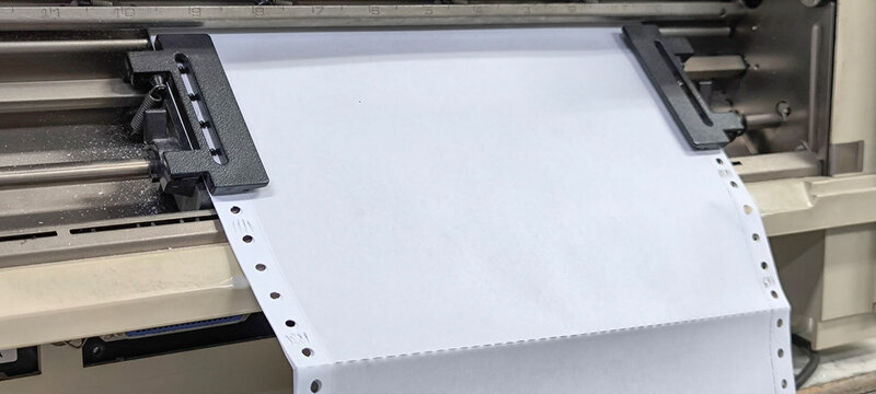 Paper in a continuous printer for printing copies.