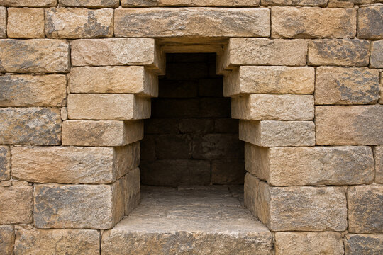 Corbelled stone opening, stepped masonry courses framing a rectangular void