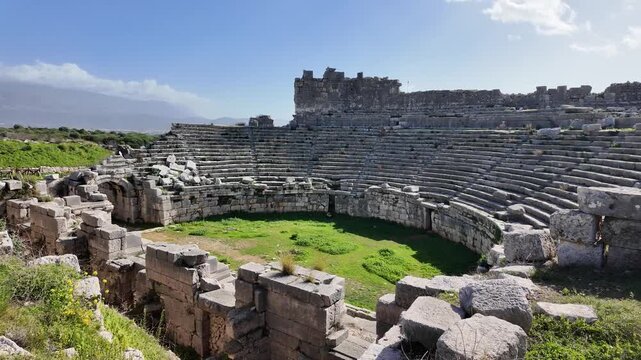 Ancient Roman theater ruins at Xanthos in Lycia, Antalya, Turkey. Stone semicircular seating tiers of an amphitheater.
