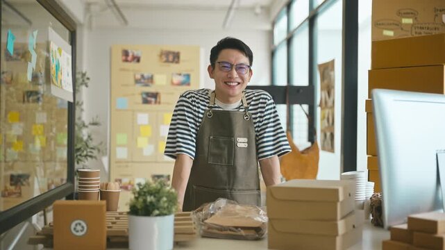 Portrait of confident Asian SME owners in shop.