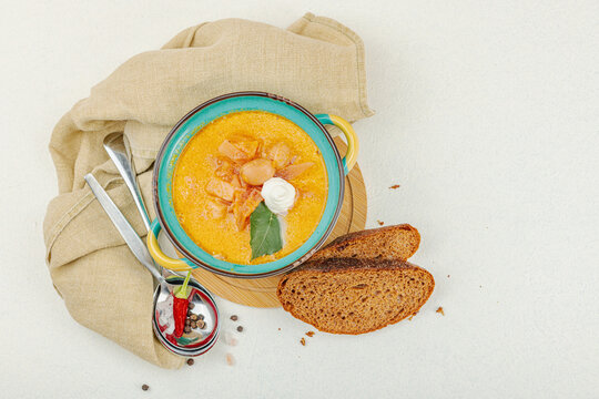 Traditional Ukrainian borscht with sour cream. Beet soup in blue and yellow ceramic pot