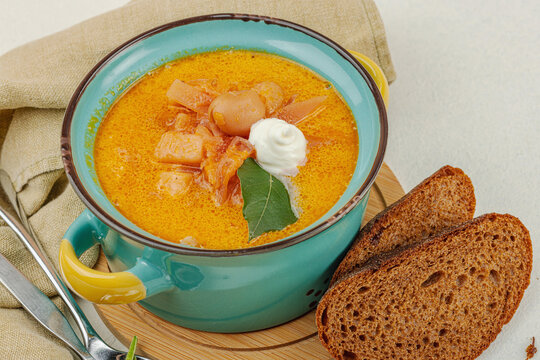Traditional Ukrainian borscht with sour cream. Beet soup in blue and yellow ceramic pot