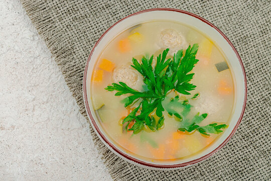 Hearty homemade Italian wedding soup with greens and meatballs