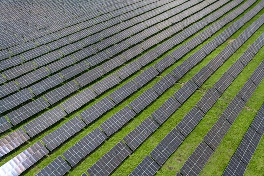 Top-Down Aerial Close-Up View of Solar PV Panel Array on Zoige Grassland: Renewable Clean Energy, Agrivoltaics, Green Field and Sunlight Background