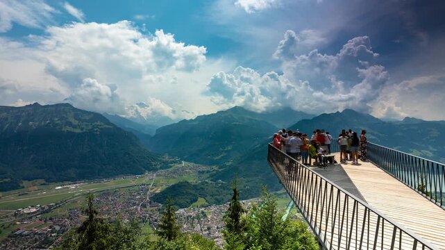 Interlaken Switzerland timelapse of rushing summer clouds over Harder Kulm viewing platform and panoramic alpine valley