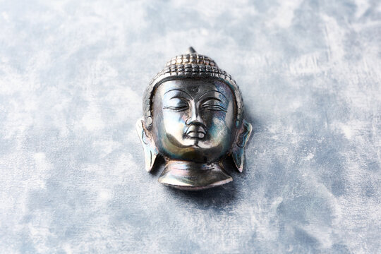 Buddha head on rustic wooden background. Soft focus. Copy space.