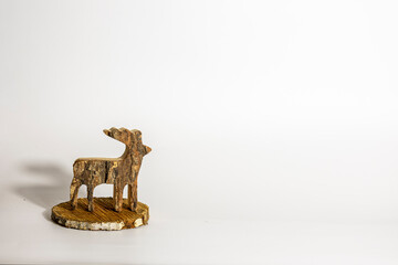 Rustic wooden reindeer Christmas decoration standing on wood slice with copy space © Wendy