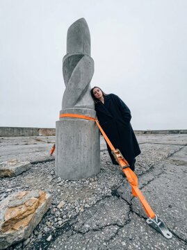 Resilience and support beside a concrete sculpture on a rooftop