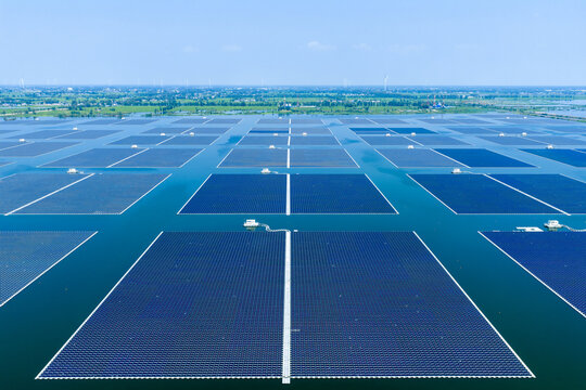Aerial view of floating solar power photovoltaic panels on water surface