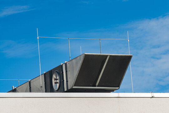 Large ventilation unit on building rooftop during clear day