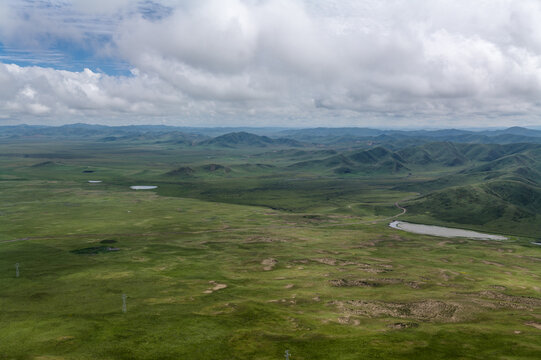 High-Angle Aerial Panoramic View of Zoige Wetland Grassland and Mountain Range in Summer: Alpine Lakes, Rolling Hills, Green Meadow, Blue Sky and Cloud Background
