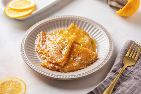 Delicious crepes suzette with orange syrup on plate. La Chandeleur. French cuisine