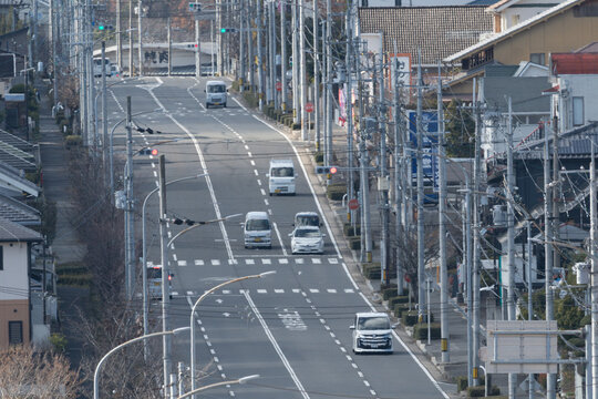 Straight Road with Cars Driving through Residential Area in Nara Japan Landscape Background with Copy Space