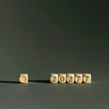 Wooden blocks showing the year 2027 with one cube fallen over, featuring worn edges and a long shadow on a cobalt background for strategy