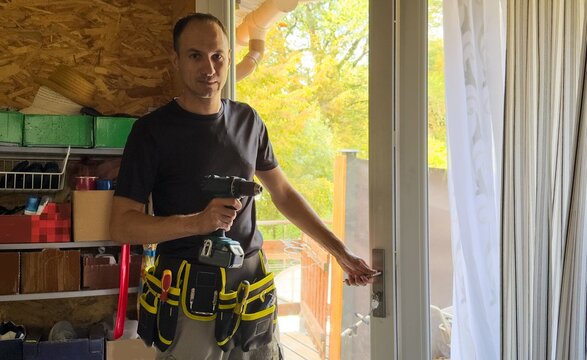 man installing aluminum frame sliding terrace doors
