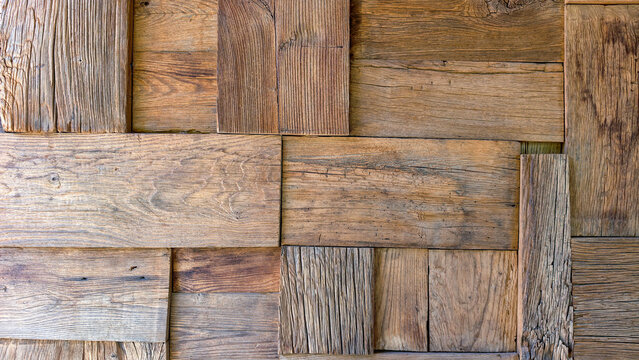 Reclaimed wood panels forming a textured, weathered surface ideal for rustic backgrounds, sustainable design, interior finishes, and eco conscious architectural projects