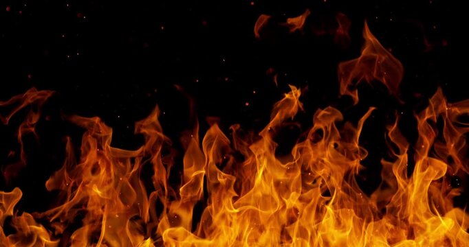 Ultra slow motion fire flames with glowing embers and sparks on black background captured at 1000 FPS. Dramatic combustion effect ideal for cinematic overlays and visual effects.