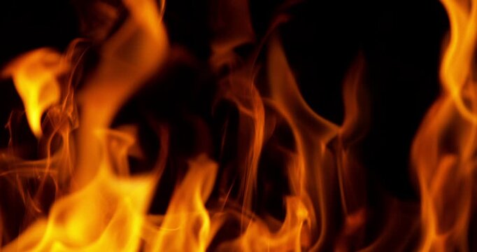 Ultra slow motion fire flames with glowing embers and sparks on black background captured at 1000 FPS. Dramatic combustion effect ideal for cinematic overlays and visual effects.