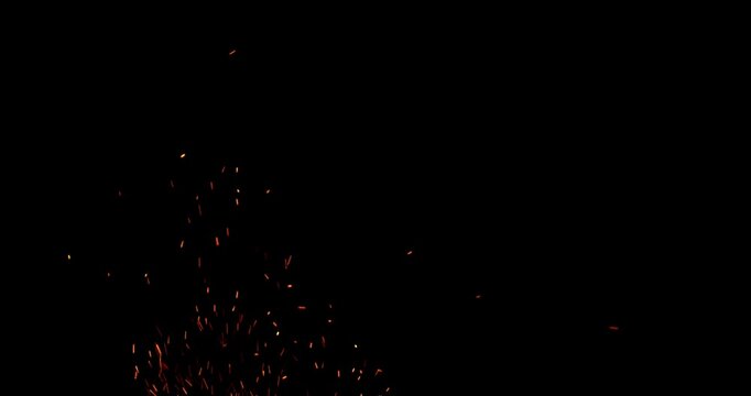 Slow motion fiery sparks flying through the air isolated on black background. Ideal as overlay effect for video editing, cinematic transitions, VFX compositing and motion graphics.