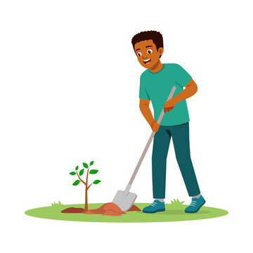 Happy African American boy smiling while planting a small tree with a shovel in a green garden