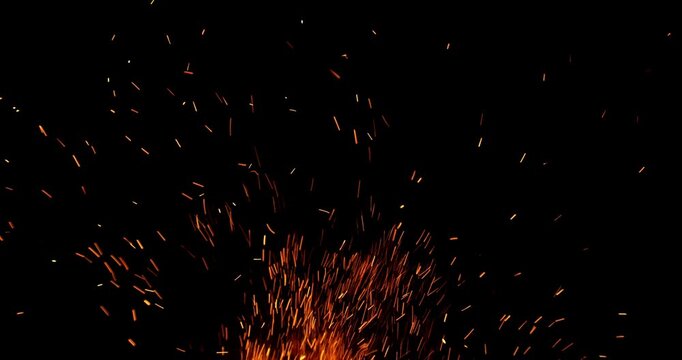 Slow motion fiery sparks flying through the air isolated on black background. Ideal as overlay effect for video editing, cinematic transitions, VFX compositing and motion graphics.