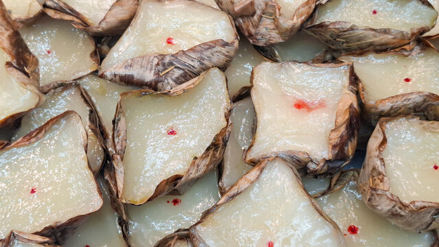 Traditional Chinese New Year Nian Gao Sweet Sticky Rice Cakes Wrapped In Banana Leaves For Offering
