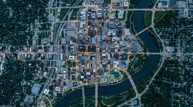 Aerial night view of a small town with a river winding through the centre