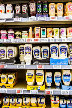 Supermarket Display with An Assortment Of Popular Mayonnaise Squeeze Bottles And Condiment Sauces