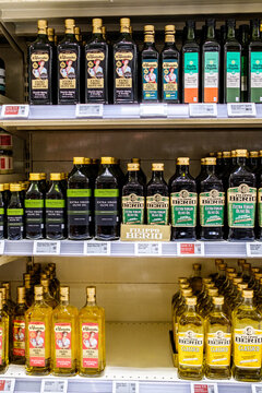 Supermarket Display With An Assortment Of Popular Branded Bottles Of Mediterrranean Olive Oil