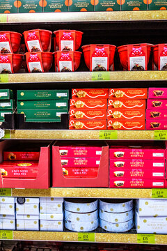 Marks And Spencer Display Of Traditional Christmas Puddings, Mince Pies, And Festive Fruit Cakes