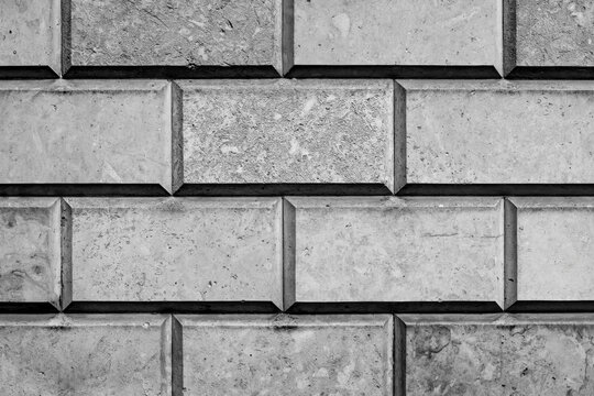 Close-up of the rusticated stonework at the base of Castle Howard in North Yorkshire, England, showing precisely cut blocks, deep joints and weathered limestone textures in black and white.