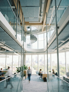 Interior view of a modern high rise office with a wide cityscape window