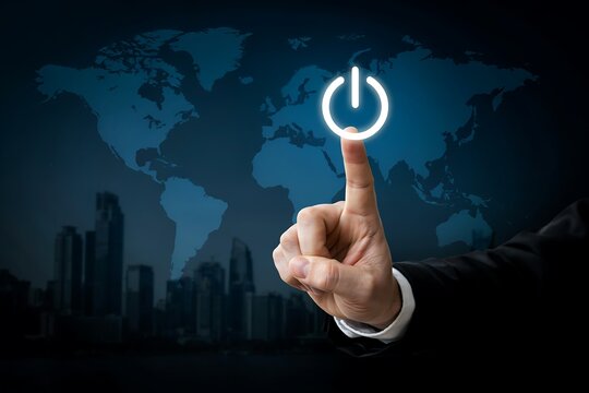Businessman finger pressing a glowing power button icon against a digital world map and city skyline
