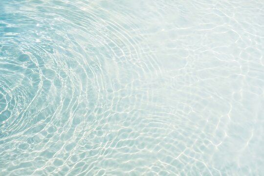 Rippling Water Surface: A close-up view of a crystal-clear water surface with gentle ripples and shimmering light reflections, evoking a sense of calm and purity.