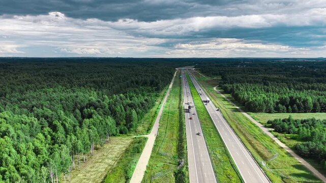 Freight trucks traveling on a divided motorway in Poland