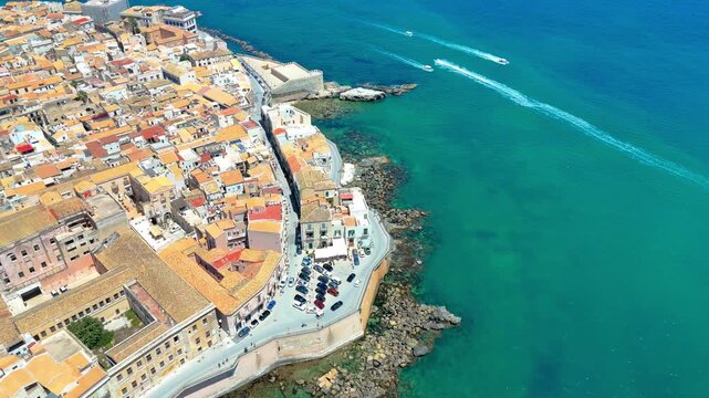 Drone footage of Ortigia island coastline and turquoise sea in Syracuse Sicily Italy