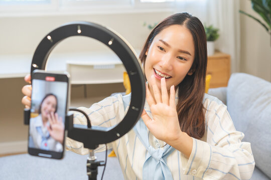 Influencer live internet, happy vlog asian young woman blogger using smart phone talking on video streaming podcast review online on social media, digital marketing with mobile content creator concept