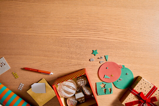 Christmas Gift Wrapping and DIY Holiday Decorations on Wooden Table with Copy Space