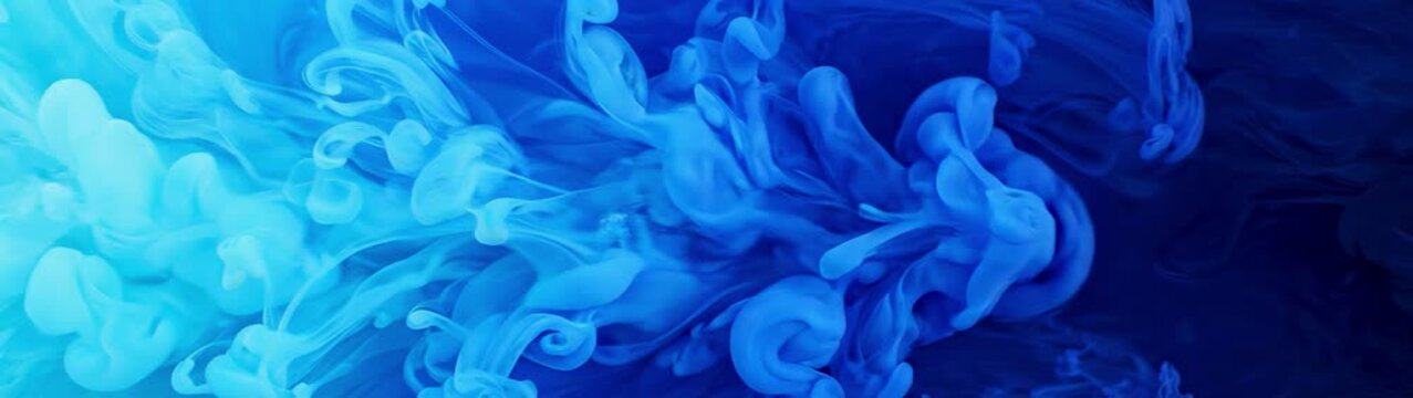 Creativity and artistic expression blue ink swirling in clear water slow motion liquid diffusion for background texture and visual design.