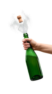 Woman holding a champagne bottle popping with sparkling spray
