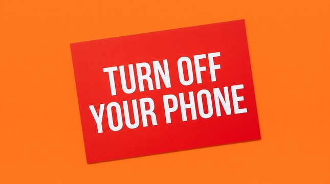 Vibrant red sign with bold white text prominently displays a clear and concise message to turn off your mobile phone, positioned against a striking orange background creating a strong visual contrast.
