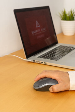 Vertical close up of hand about to click computer mouse