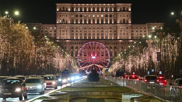 A scenic night-time shot of the Bucharest Christmas Market in Romania. The iconic Palace of the Parliament stands illuminated in the background, while a colorful Ferris wheel.