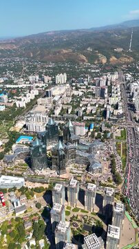 ALMATY, KAZAKHSTAN - AUGUST 28, 2026: Drone view of financial district and Kok Tobe hill