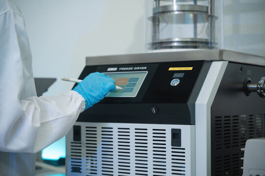 Cropped of Scientist Operating Freeze Dryer Machine with Touchscreen Control Panel in Laboratory