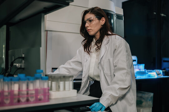 Female Scientist Working in Modern Research Laboratory with Test Tubes and Scientific Equipment